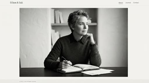 A striking black and white portrait of a thoughtful intellectual writer, looking off-camera with a serene expression.
